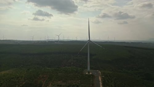 Drone view of wind farm generating alternative green energy. Wind turbines rotating at windmill park