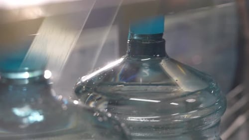 Manufacturing And Filling Plastic Bottles With Drinking Water. Plastic Water Bottles on a Factory