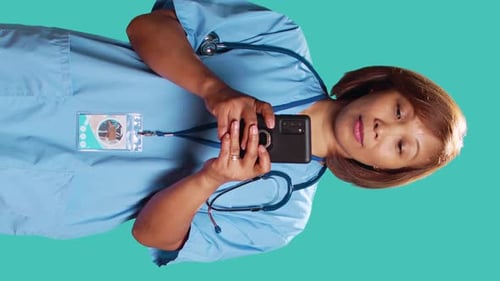 Nurse Texting on Smartphone at Work