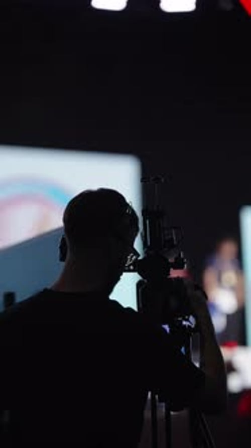 Cameraman filming event with digital cinema camera