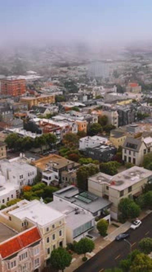 Thick white fog spreading over the city. Aerial footage of beautiful San Francisco