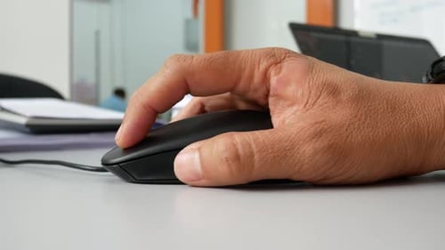 A man hand using black computer mouse