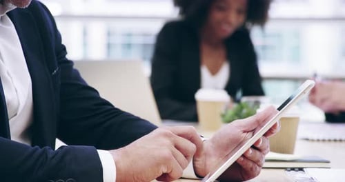 Smiling Man Uses Tablet at Office Meeting