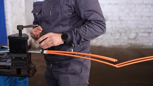 Man working with wires and machine indoors
