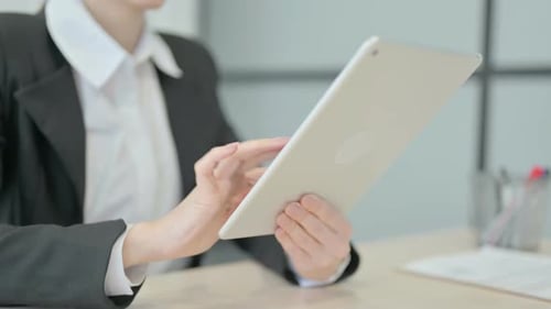 Close up of Businesswoman Browsing Internet on Tablet
