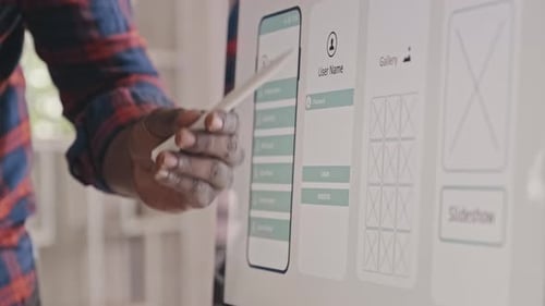 UX Designer Presenting Mobile App Wireframe on Computer