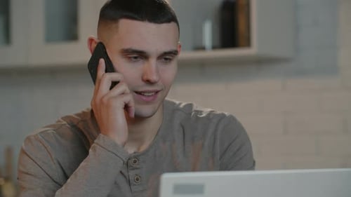Young Adult Talking on Phone in Home