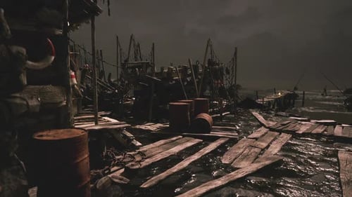 Dark Pier with Fishing Equipment and Barrels During Nighttime