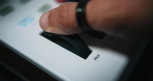 Finger Adjusting Pitch Fader on Music Technology