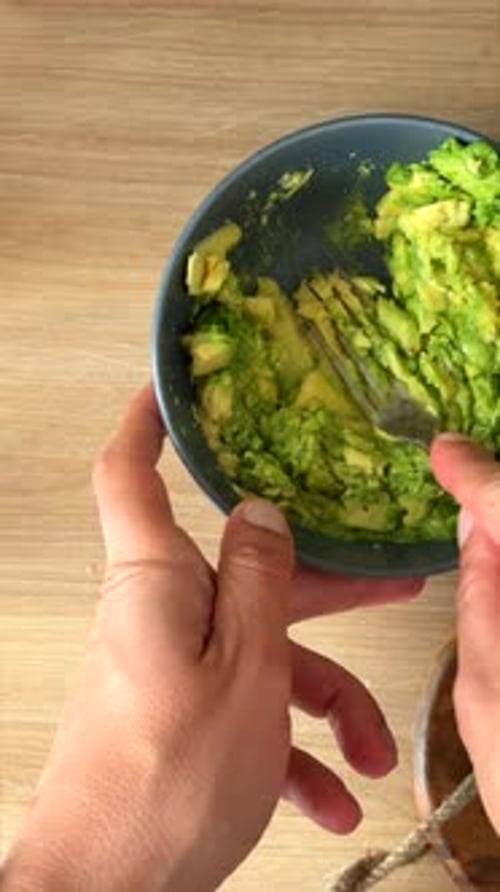 Mashing Avocado in Bowl with Fork