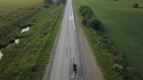Aerial View of Motorcyclist Riding on Rural Highway Clip