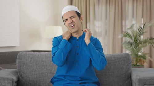 Man Rubbing Neck in Pain