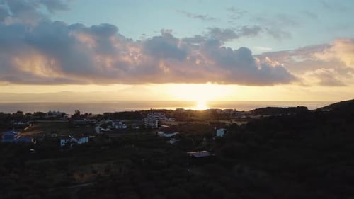 Drone view over the village during sunset in summer month.