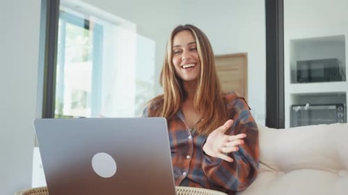 Cheerful Woman Talking on Laptop at Home Enjoying Video Call and Online Communication Remote Work