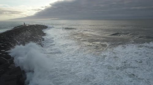 Ocean Waves Crashing on Rocky Wave Breaker