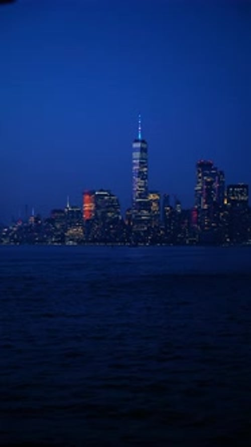 Night view of Manhattan skyline with One World Trade Center.