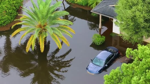 Flooded Street with Stuck Car After Hurricane Rainfall in Florida Aftermath of Natural Disaster