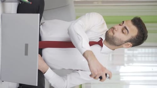 Adult Man Applying Pain Relief While Working at Home