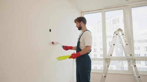 Close Up of Male in Gloves Holding Painting Roller