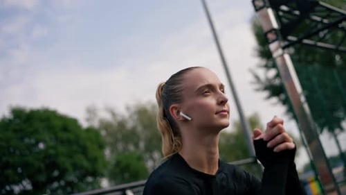Athletic Woman Stretching Arms on Court