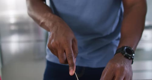 Man Slices Fresh Mushrooms in Kitchen