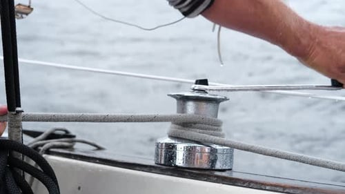 Close Up of Male Hands Pulling Rope of Sailboat Yachtsman Hands Dealing with Yacht Ropes on Halyard