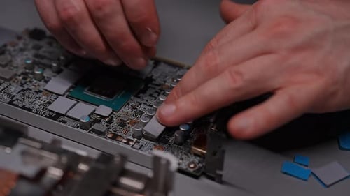 Hands Installing Computer Chip with Silicone Pads