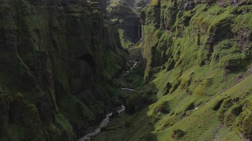 Aerial View of Moss Covered Canyon with Waterfall in Iceland