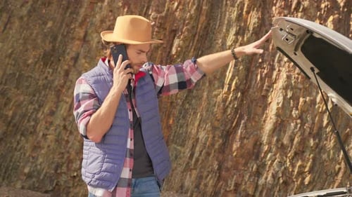 Car Trouble Bearded Young Man with Phone Calling Emergency Services for Car Help Opened Car Hood