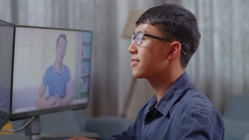 Asian Boy Programmer Learning Online From Teacher While Creating Software Engineer Developing App