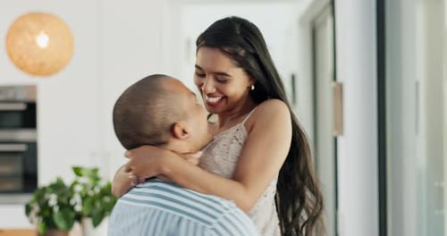 Affectionate Couple Embracing and Kissing in Kitchen