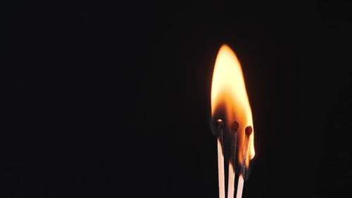 Matches Igniting and Burning in Macro on Black