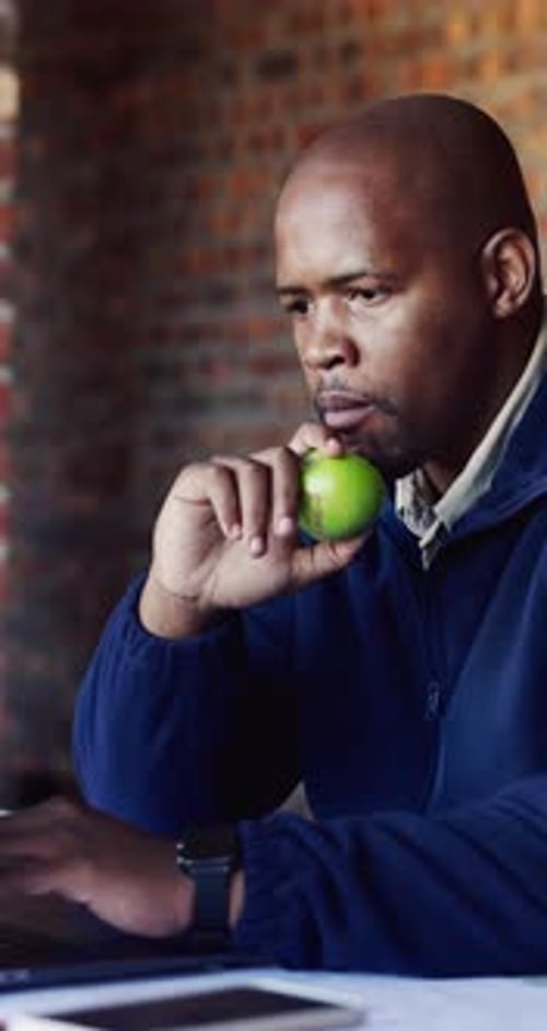 Architect, laptop and snack with black man on construction site for planning or research