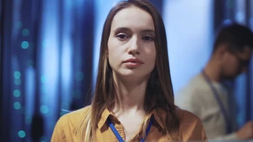 Woman standing in front of server racks