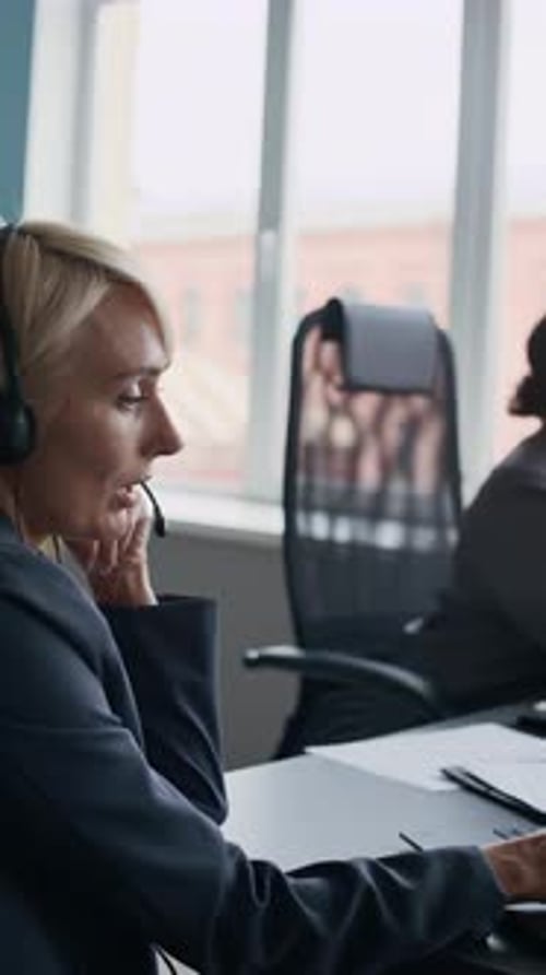 Blond Operator Pointing at Laptop Screen while Explaining Information