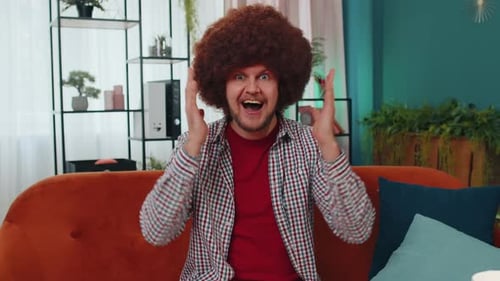 Man With Afro Reacts With Surprise and Happiness