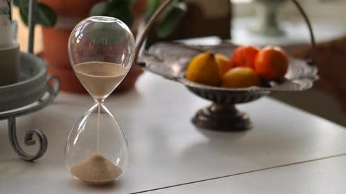 Classic Hourglass on Table with Fruit