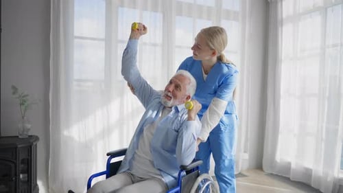 Nurse Assists Senior Man with Dumbbell Exercises