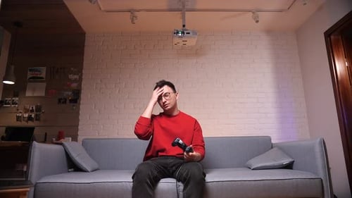 Young Man Playing Video Games on Couch