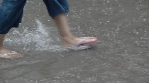is walking in a puddle of rain