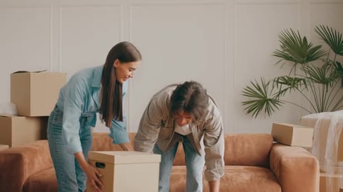 Family Relocating to a New Apartment While Packing Boxes and Furniture