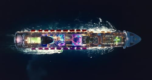 Aerial View of Illuminated Large Cruise Ship in the Open Sea at Night