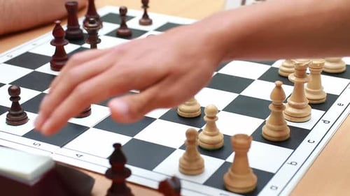 Chess Board and Hand Making a Move
