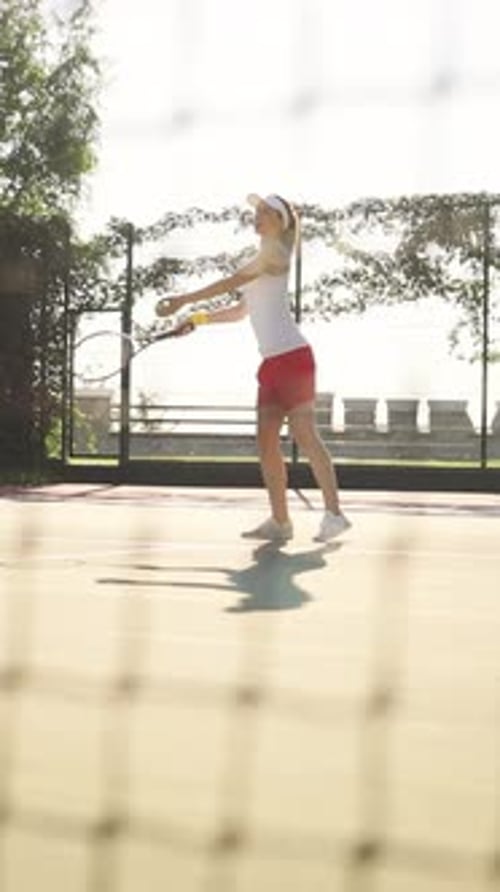 A Female Tennis Player Engaged in Her Practicing Routine on the Court Displaying Focus and Skill