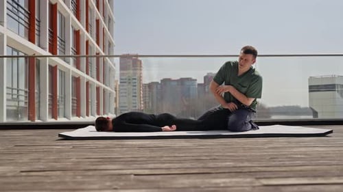 Physical Therapist Working on Patient's Leg Outside