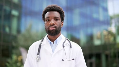 Confident Young Adult Doctor in Lab Coat Close Up