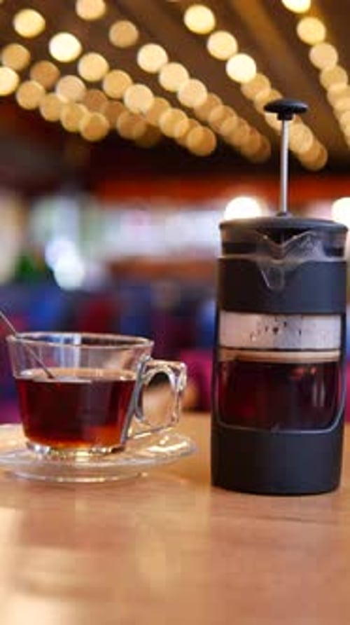 Enjoying Freshly Brewed Tea at a Cozy Cafe During the Afternoon