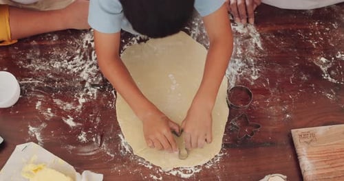 Kid, hands and baking with dough in top view in kitchen with help in home with support