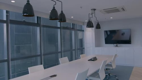Tilt Down Shot Of A Stylish And Modern Meeting Room In A Corporate Office With A High Building View