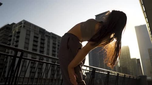 Elegant Woman Dancing in an Urban Landscape